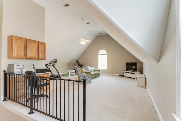 interior space featuring ceiling fan, carpet flooring, visible vents, baseboards, and vaulted ceiling