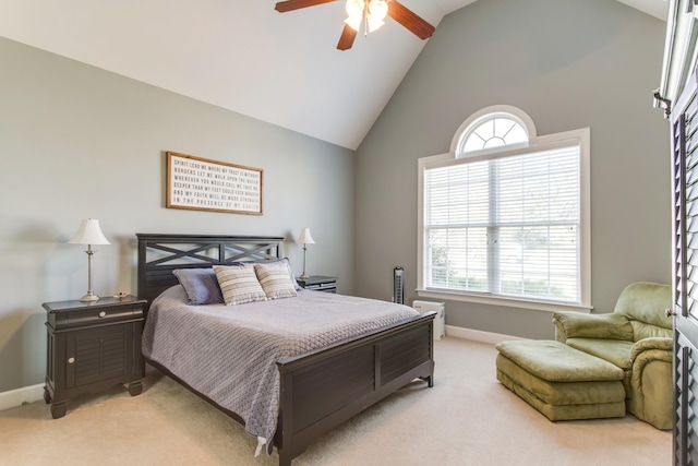 bedroom featuring high vaulted ceiling, light carpet, baseboards, and a ceiling fan