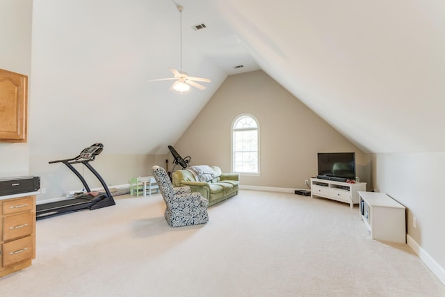 sitting room featuring lofted ceiling, visible vents, baseboards, and light colored carpet