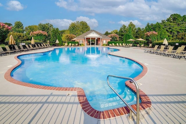 community pool featuring a patio and fence