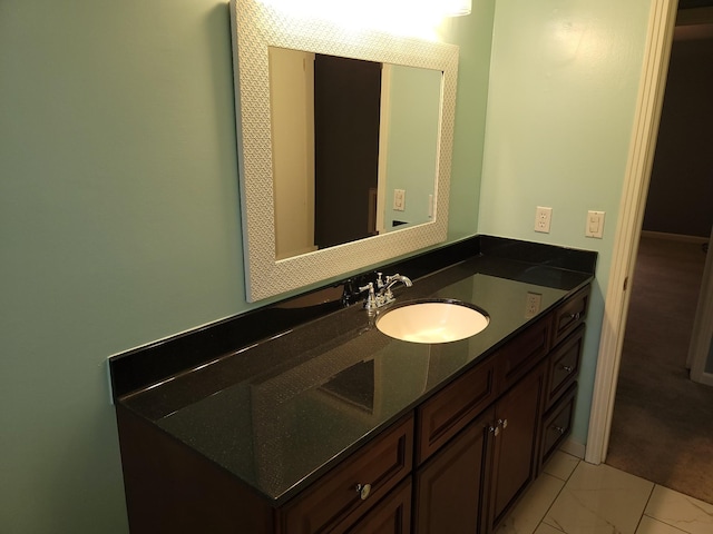 bathroom with marble finish floor and vanity