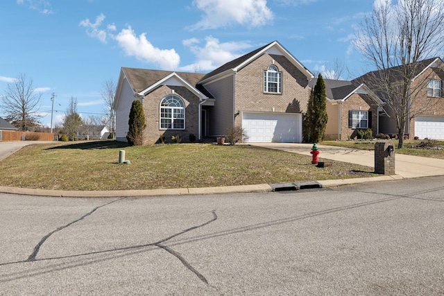 traditional-style house featuring an attached garage, concrete driveway, brick siding, and a front yard