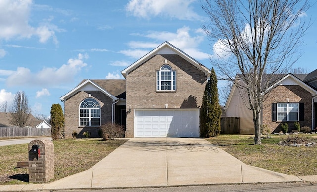 traditional-style house with driveway, brick siding, an attached garage, fence, and a front yard