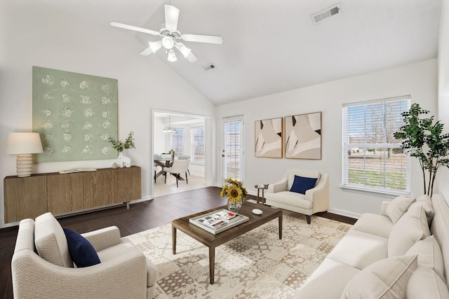 living area with a healthy amount of sunlight, visible vents, and dark wood finished floors