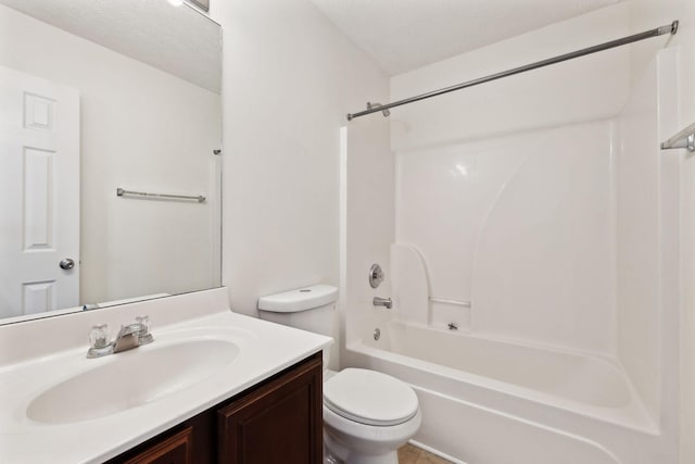 bathroom featuring a textured ceiling, shower / bath combination, vanity, and toilet