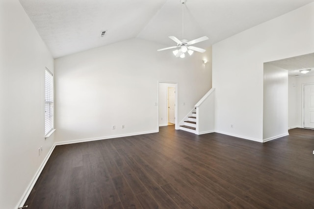 unfurnished room featuring visible vents, dark wood-type flooring, a ceiling fan, baseboards, and stairs