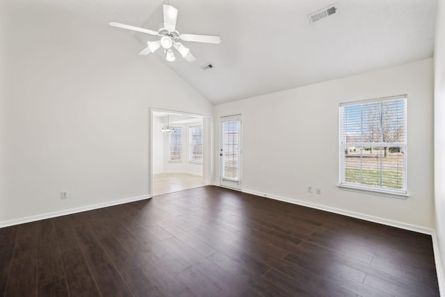 empty room with dark wood finished floors, visible vents, and plenty of natural light