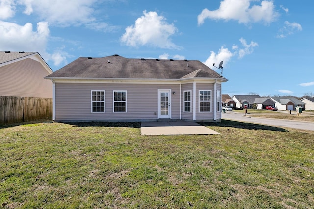 back of house featuring fence, a patio, and a yard