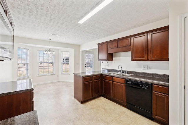 kitchen with a textured ceiling, a sink, dishwasher, dark countertops, and pendant lighting