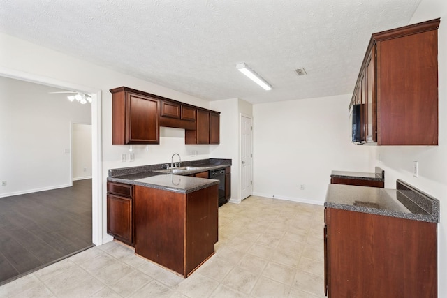 kitchen with a textured ceiling, a peninsula, a sink, visible vents, and dishwasher