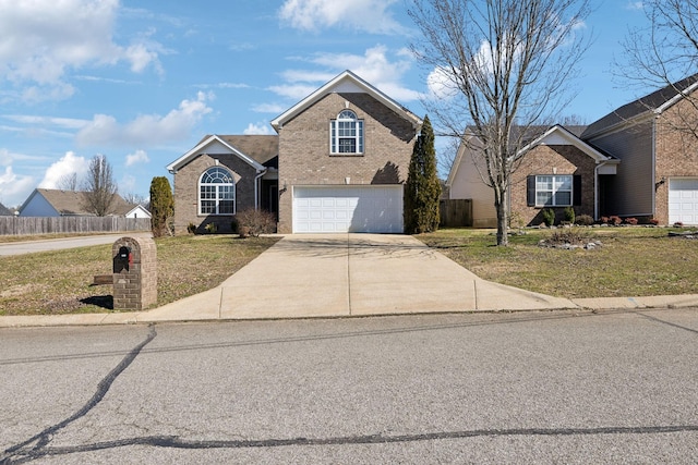 traditional-style home with a garage, brick siding, fence, concrete driveway, and a front yard