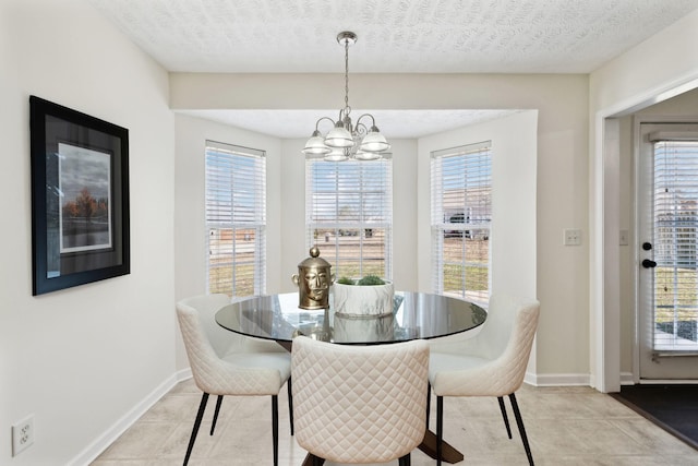 dining space featuring an inviting chandelier, baseboards, and a textured ceiling