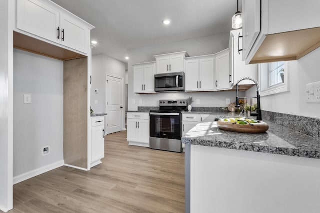 kitchen featuring appliances with stainless steel finishes, light wood-type flooring, a sink, and white cabinetry