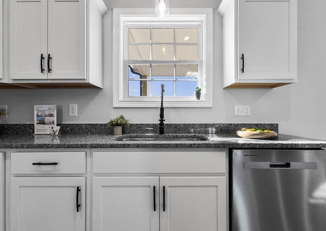 kitchen featuring a sink, dark stone countertops, white cabinetry, and dishwasher