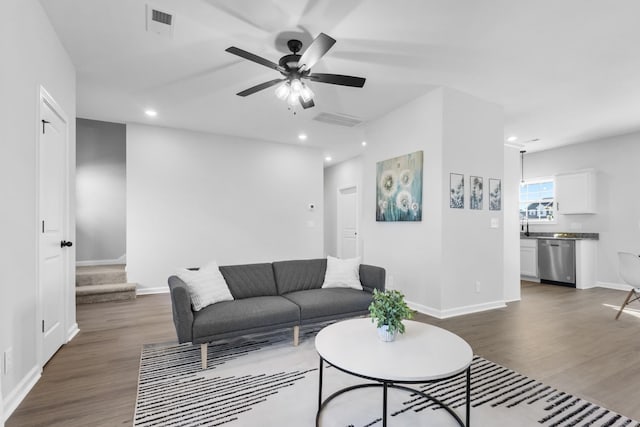 living area featuring baseboards, a ceiling fan, dark wood-style flooring, stairs, and recessed lighting