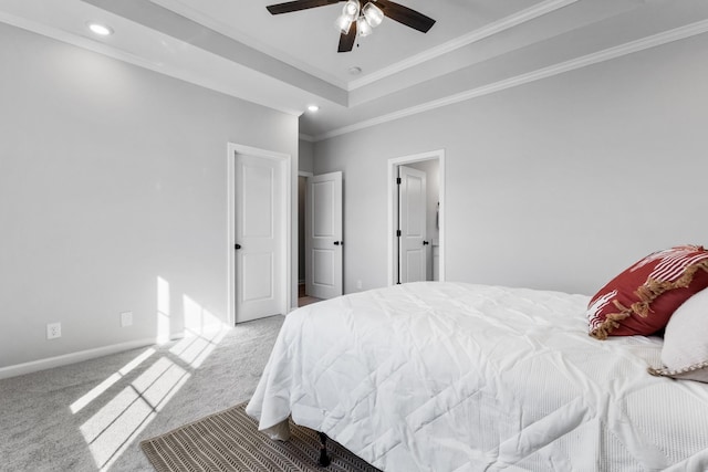 bedroom featuring carpet, crown molding, recessed lighting, a raised ceiling, and baseboards