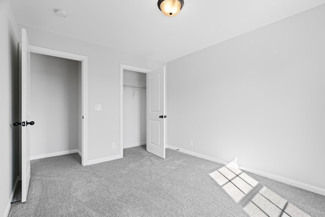 unfurnished bedroom featuring carpet floors, a closet, and baseboards