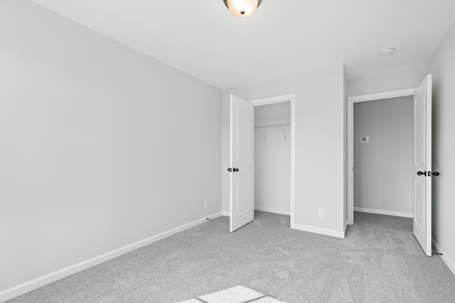 unfurnished bedroom with carpet, baseboards, and a closet