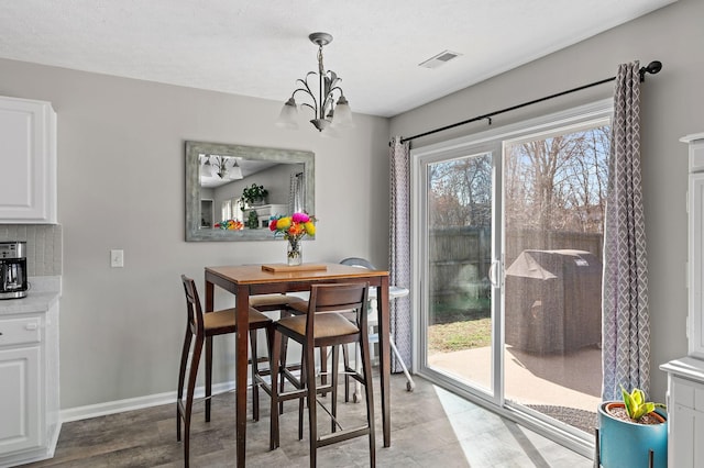 dining room featuring visible vents, baseboards, and an inviting chandelier