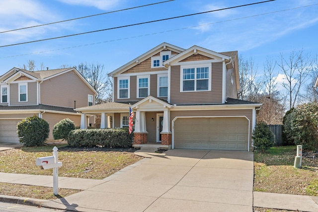 craftsman house with a garage, driveway, and brick siding