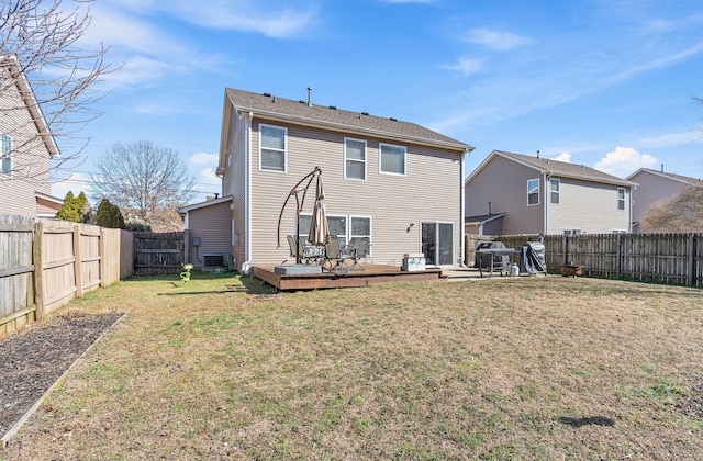 rear view of property featuring a fenced backyard, a lawn, a wooden deck, and central air condition unit