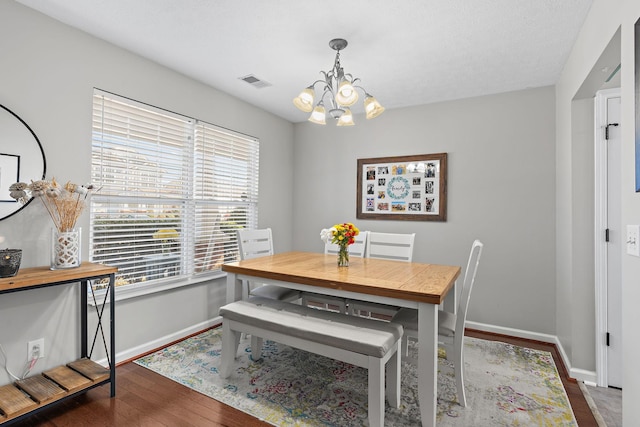 dining space featuring hardwood / wood-style flooring, plenty of natural light, visible vents, and baseboards