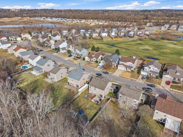 drone / aerial view with a water view and a residential view