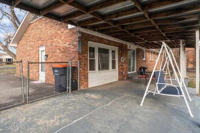 view of patio / terrace featuring a gate and fence