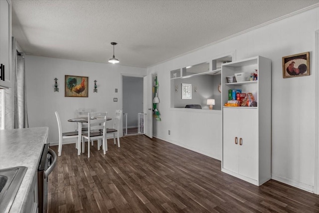 dining space with a textured ceiling and dark wood-type flooring