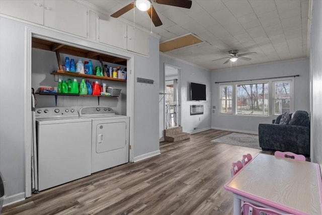 laundry room featuring attic access, baseboards, wood finished floors, independent washer and dryer, and crown molding