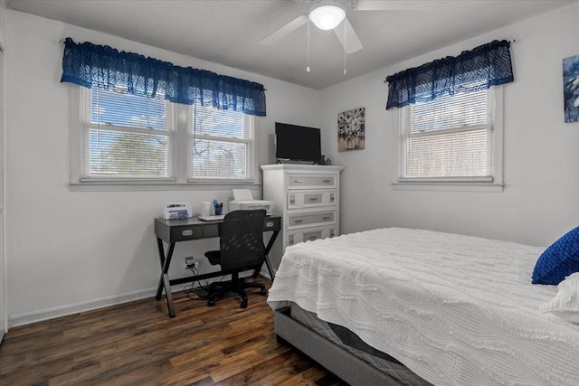 bedroom with dark wood-style floors, ceiling fan, and baseboards