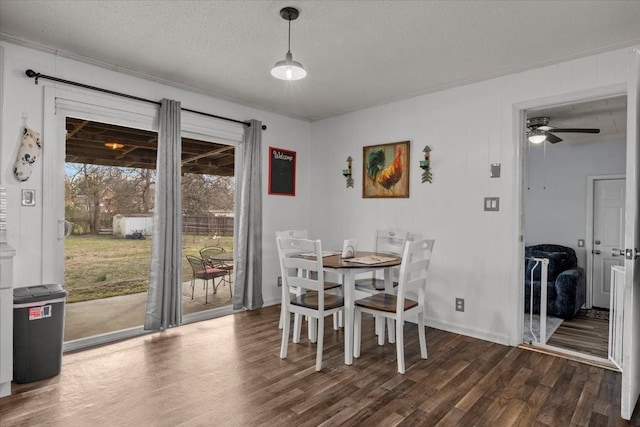 dining room with dark wood finished floors, a textured ceiling, and ceiling fan