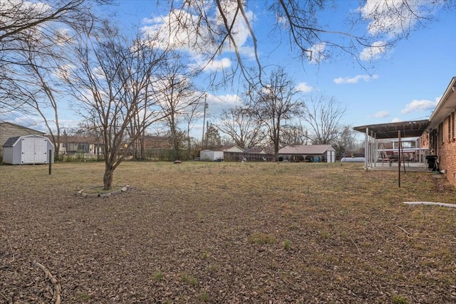 view of yard featuring a sunroom, an outdoor structure, and a shed