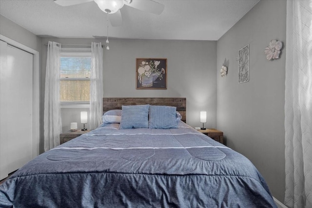 bedroom with a ceiling fan and a closet