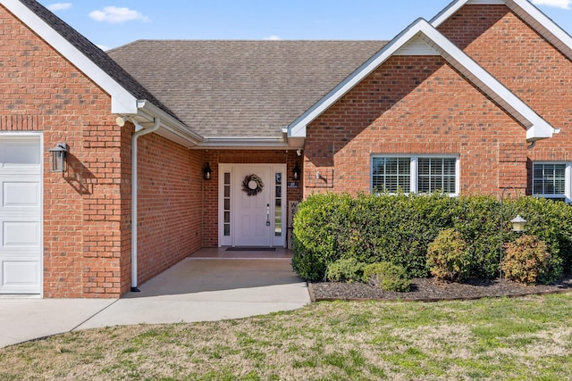 view of front of home featuring a garage, brick siding, and roof with shingles