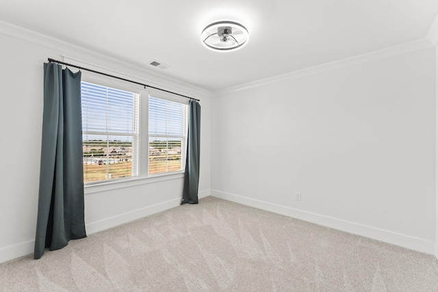 empty room featuring baseboards, visible vents, crown molding, and carpet flooring