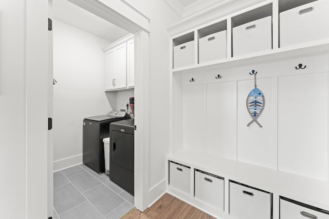 mudroom featuring baseboards and separate washer and dryer