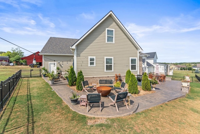 back of house with a fire pit, a patio, a yard, and fence