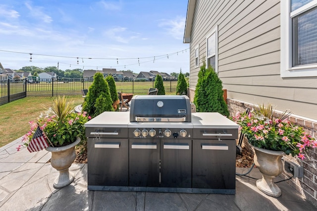 view of patio with fence and an outdoor kitchen