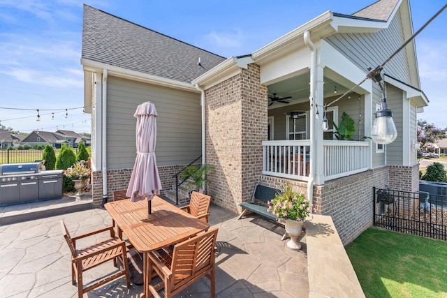 view of patio / terrace featuring a ceiling fan, outdoor dining space, fence, and a porch