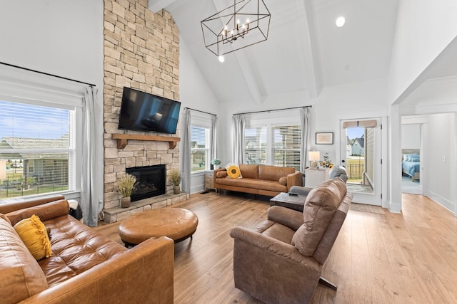 living area featuring high vaulted ceiling, a wealth of natural light, and light wood-style flooring