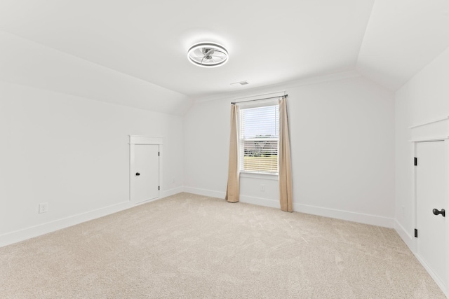 bonus room featuring lofted ceiling, light carpet, visible vents, and baseboards