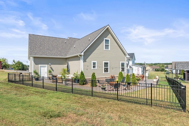 rear view of property featuring a patio area, a fenced backyard, and a yard