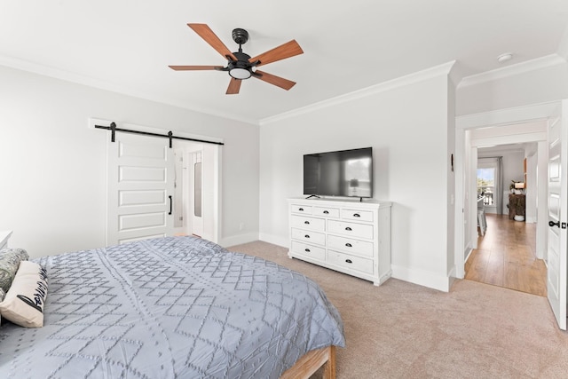 bedroom with light carpet, a barn door, ornamental molding, and baseboards