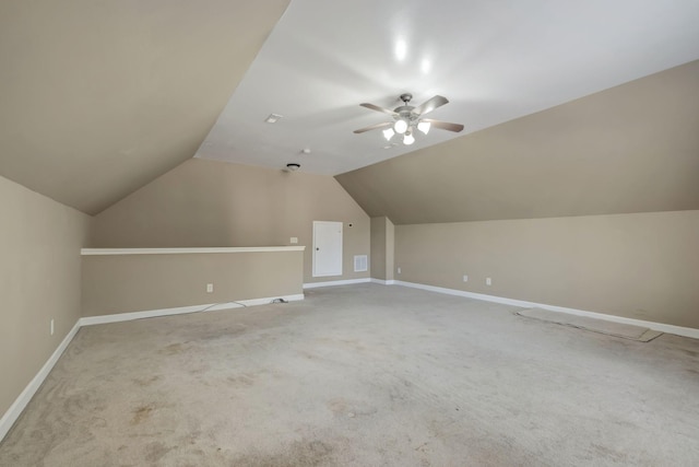 additional living space featuring vaulted ceiling, ceiling fan, carpet flooring, and baseboards