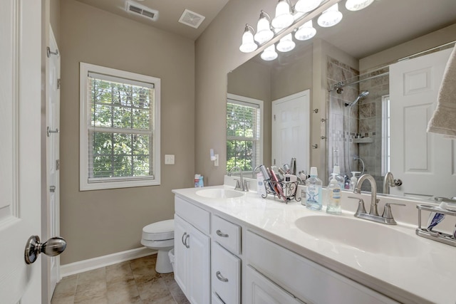 bathroom with toilet, visible vents, and a sink