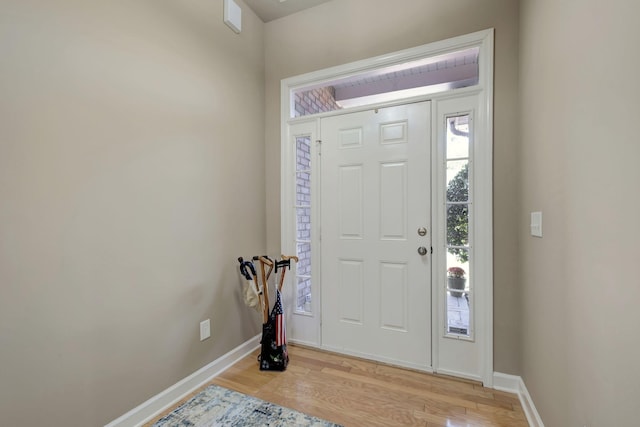 foyer featuring light wood-style floors and baseboards