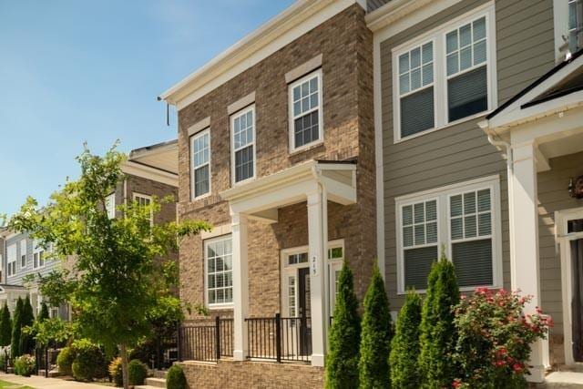 townhome / multi-family property featuring brick siding