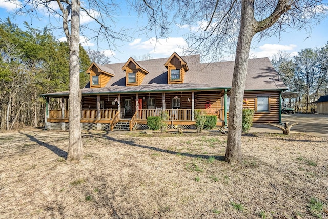 log home featuring covered porch and roof with shingles