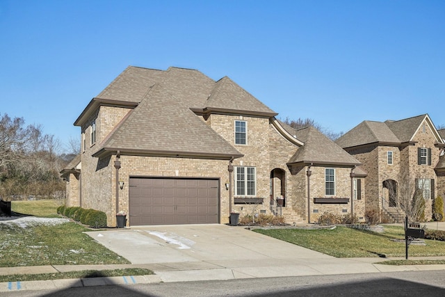 french provincial home featuring brick siding, roof with shingles, a front yard, a garage, and driveway